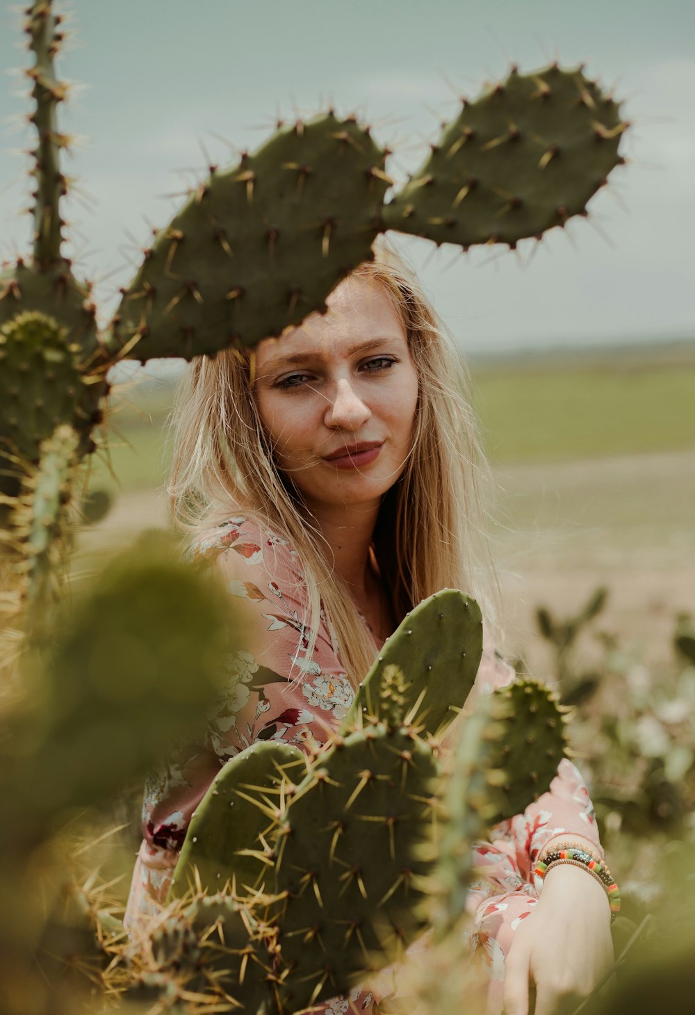 woman standing near the cactus plant