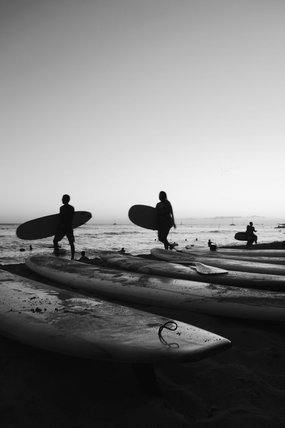 people on seashore in grayscale photo