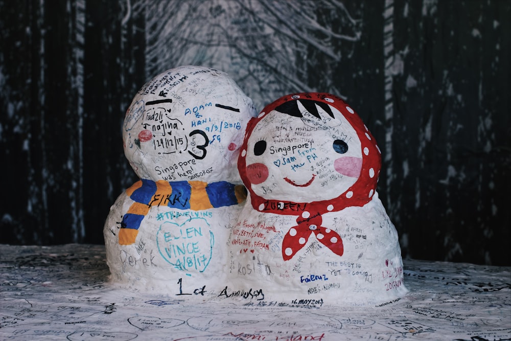 two white and multicolored snowmen decor