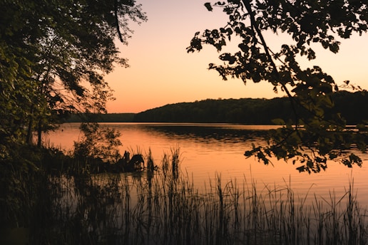 A serene retreat setting with peaceful nature surroundings and a calm lake at sunset.