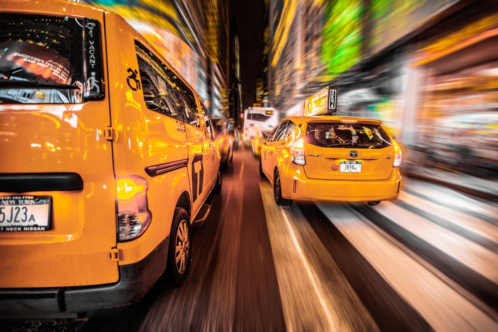 yellow van near 5-door hatchback on road