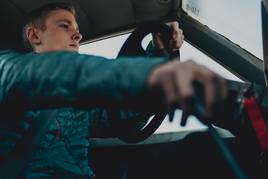 man wearing black jacket driving on vehicle