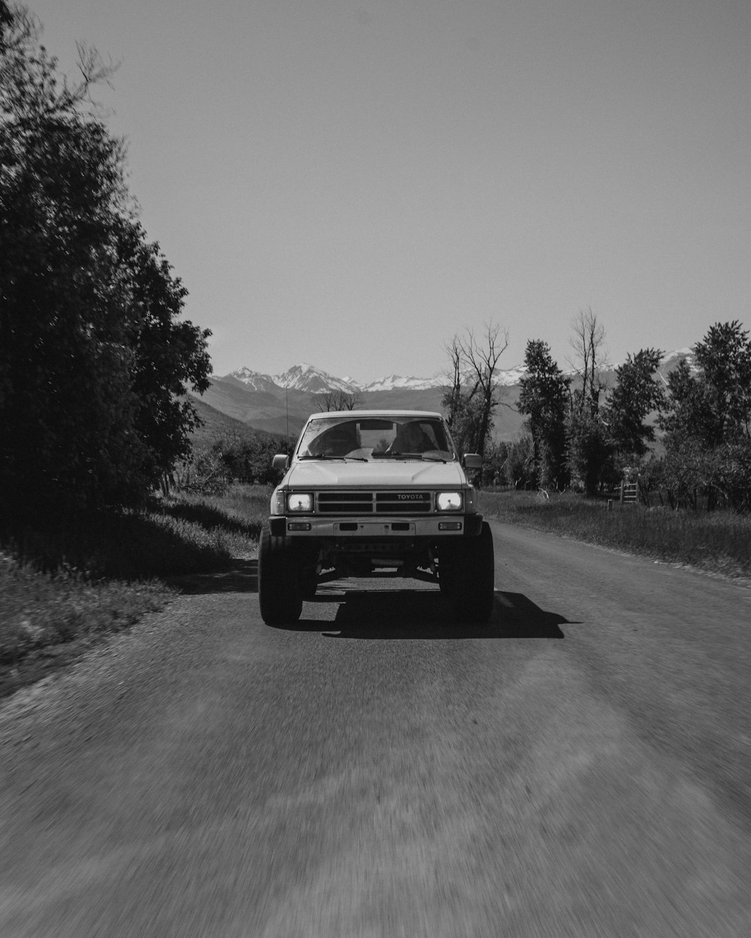 grayscale photography of vehicle on road