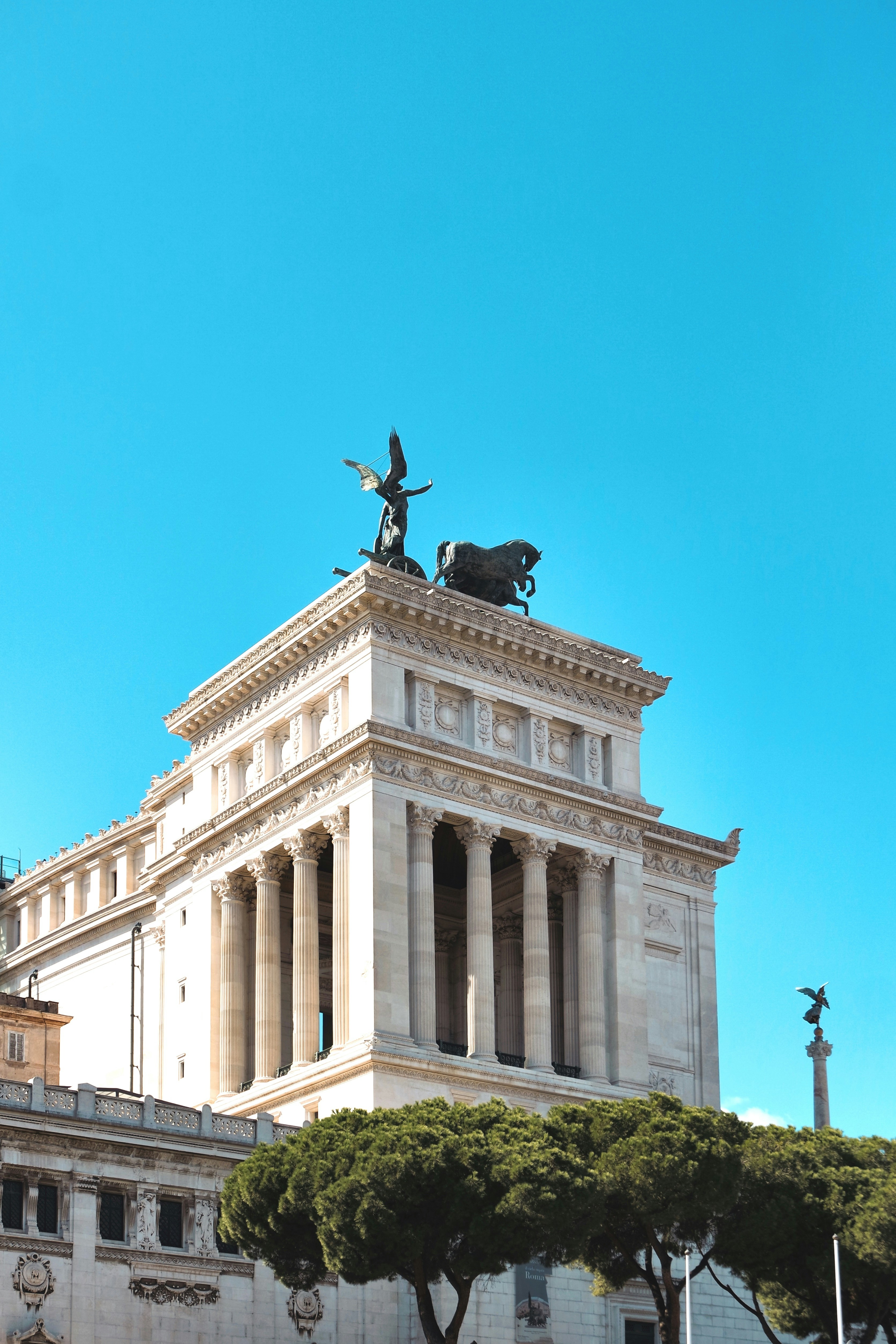 Statue on top of building during day photo Free Altare della patria