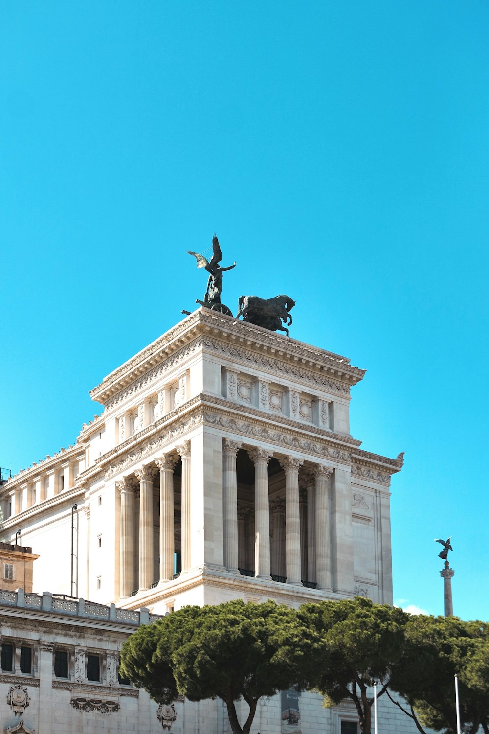 statue on top of building during day