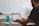 man sitting at the table while using laptop computer