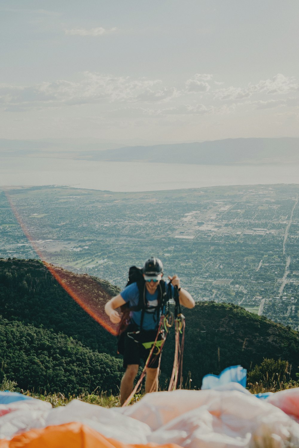 man hiking to far from body of water at daytime