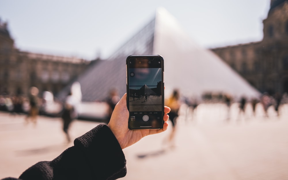 person using black iPhone