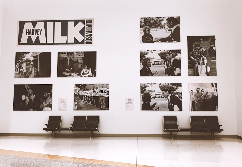 empty gang chairs beside wall with photo frames