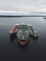 black and brown ships under cloudy sky