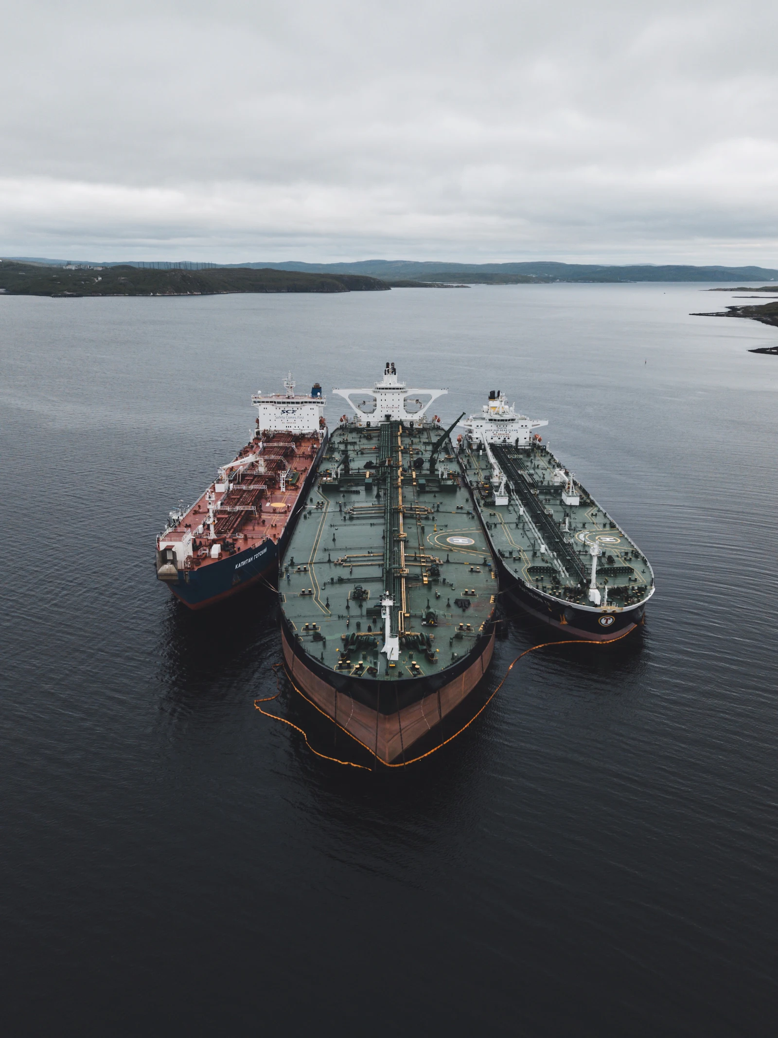 Three oil tankers moored side by side at sea