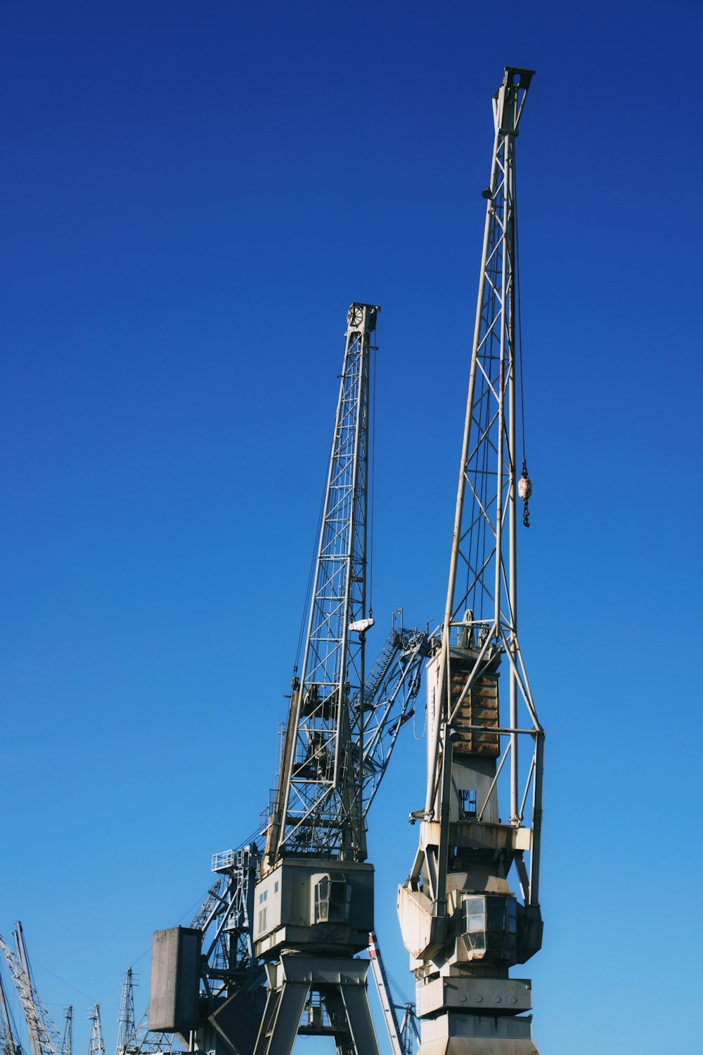 two gray metal cranes