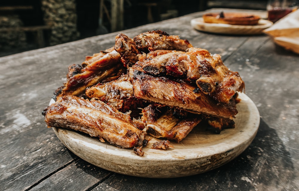 grilled ribs on brown wooden tray