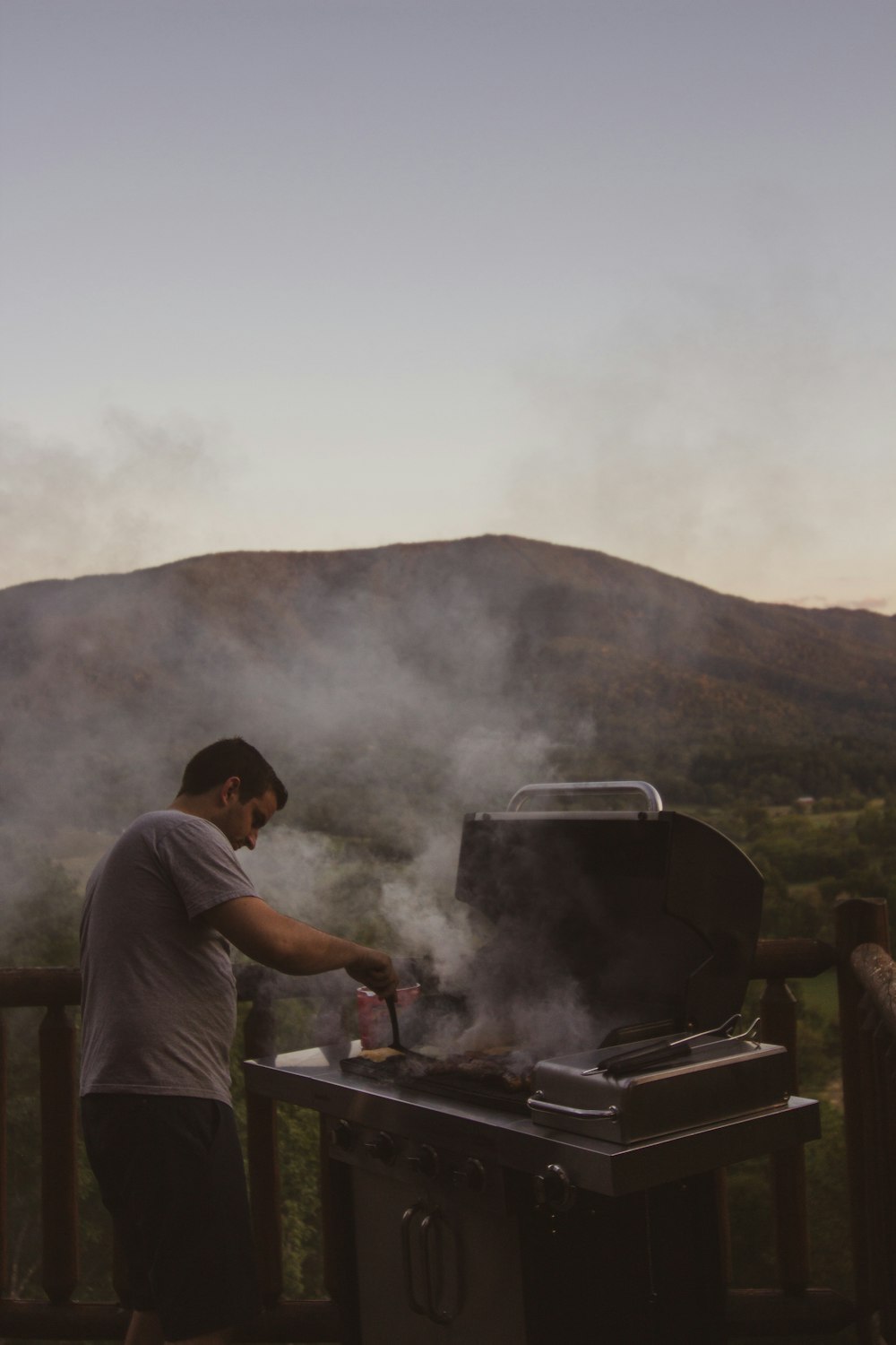 man cooking on charcoal grill