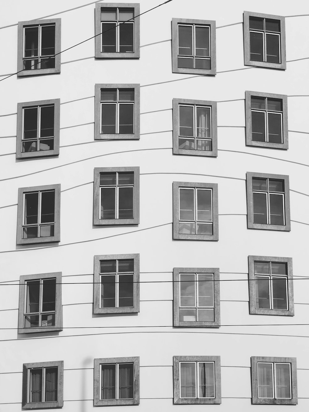 Photo en niveaux de gris des fenêtres des bâtiments
