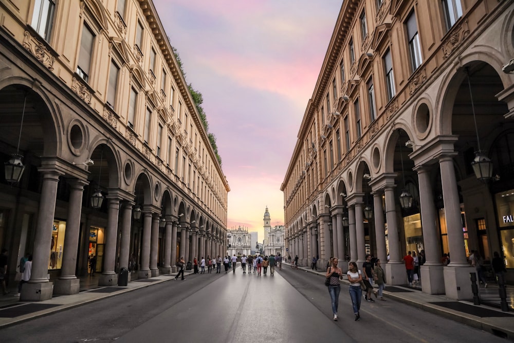 people walking on street between buildings