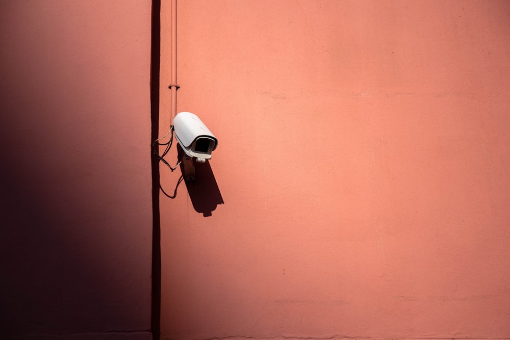 white bullet CCTV camera on wall