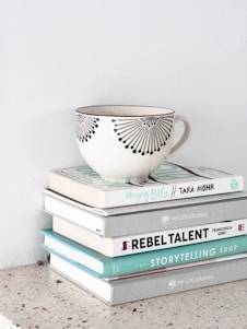 a teacup on top of stacked books