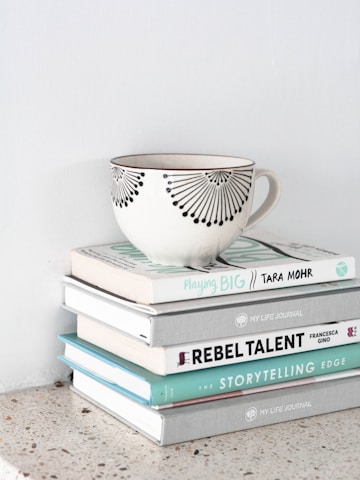 a teacup on top of stacked books