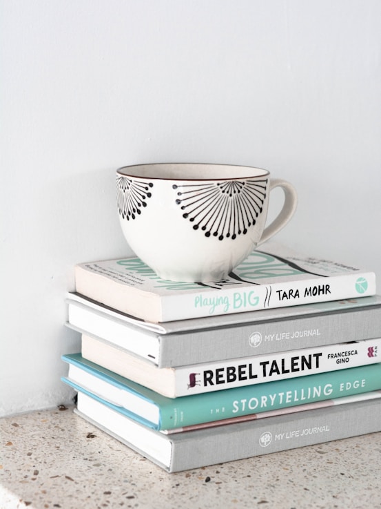 a teacup on top of stacked books
