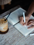 person writing on book
