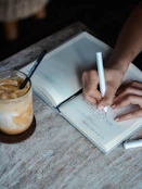 person writing on book