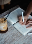 person writing on book