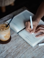 person writing on book