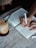 A person writing goals in a notebook with a cup of coffee beside them.