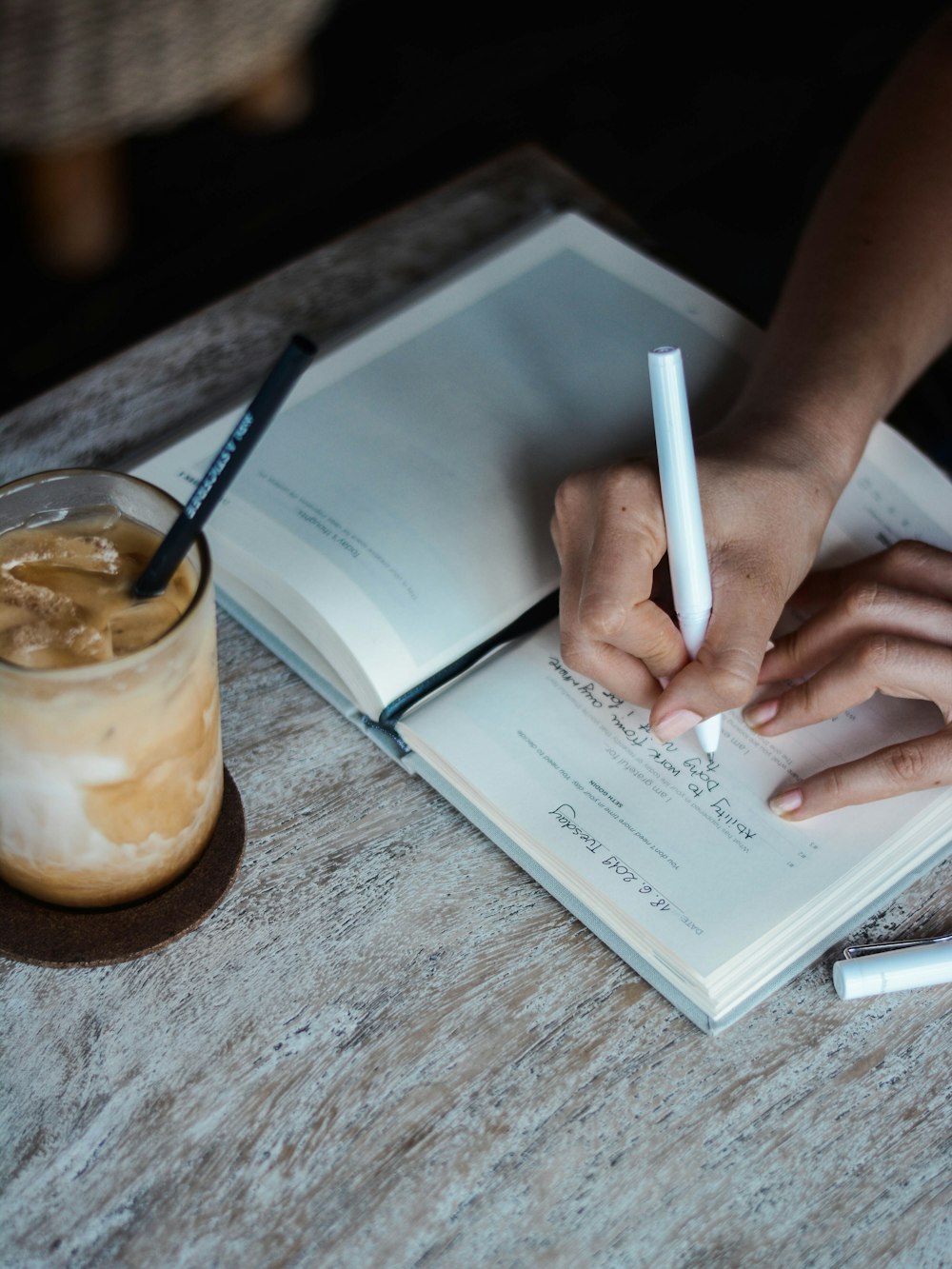 person writing on book