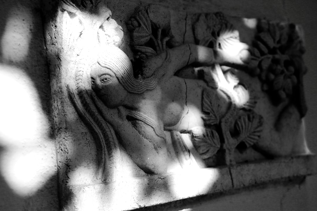 grayscale photo of woman embossed wall decor