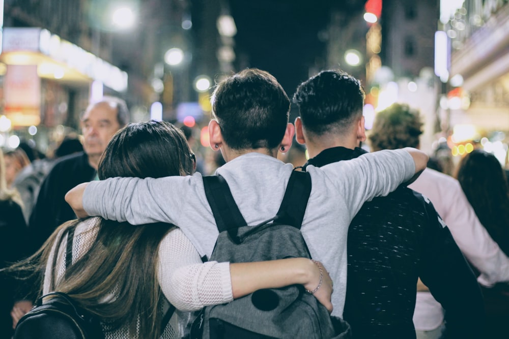 people gathered outside buildings at night