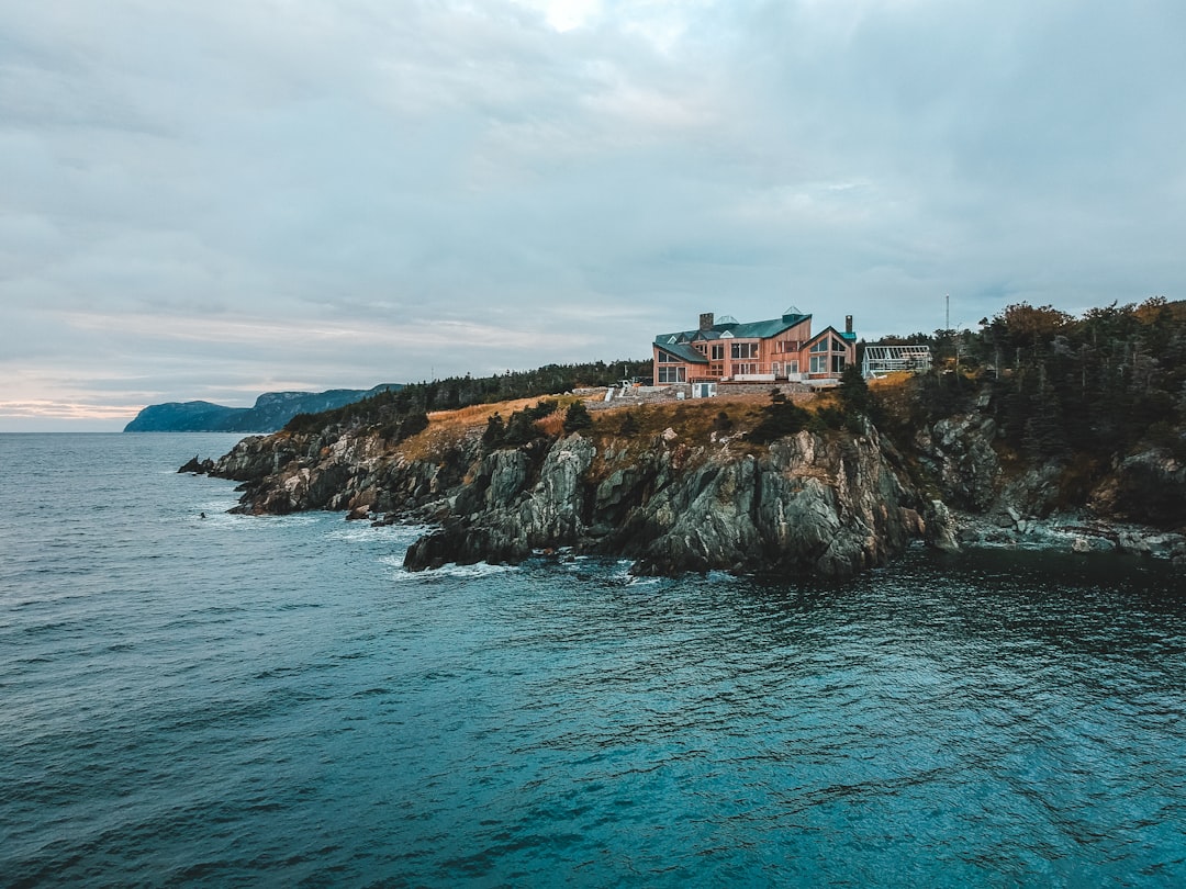 brown house on mountain near oceanm