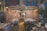 A cozy music store filled with vinyl records and DVDs, featuring colorful graffiti on the walls. Shelves are lined with a vast collection of CDs and records in an organized manner. Soft lighting adds to the inviting atmosphere, and a few customers are browsing the selection.