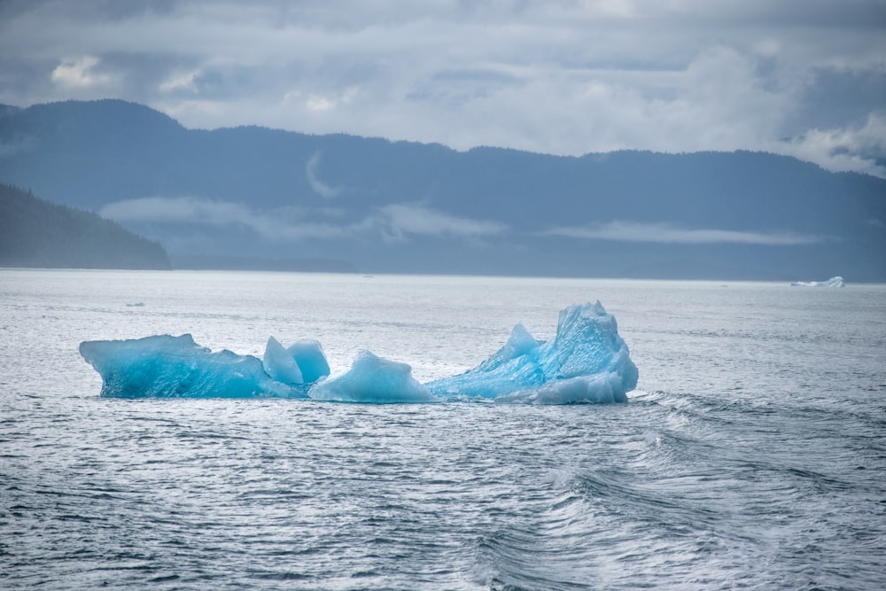 white and blue ice formation on sea viewing mountain during daytime