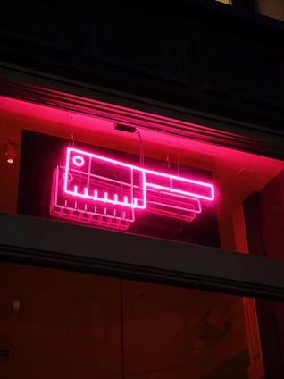 A shadowy butcher shop bathed in deep reds and blacks, with a flickering neon sign casting eerie light.