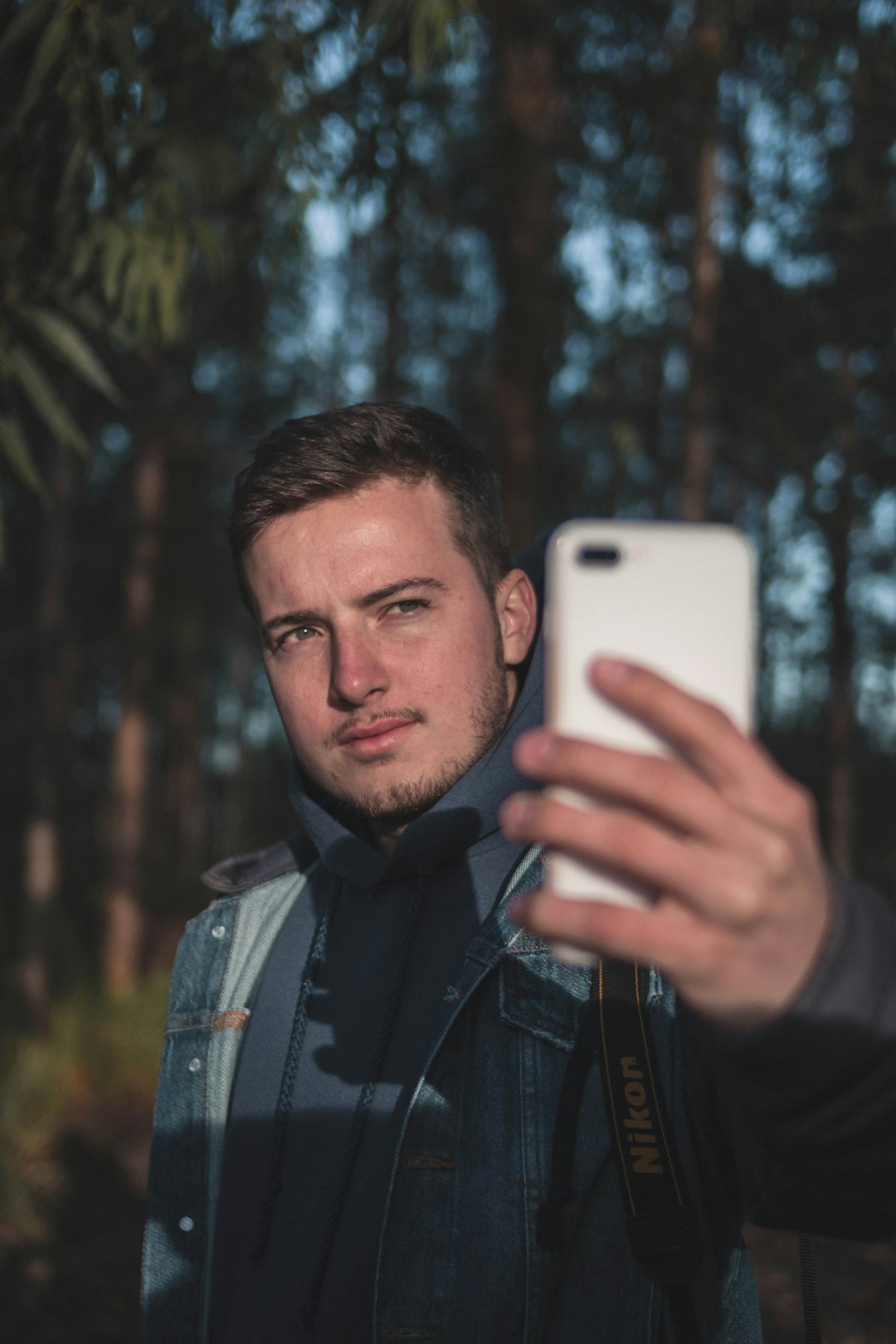 man holding white Android smartphone