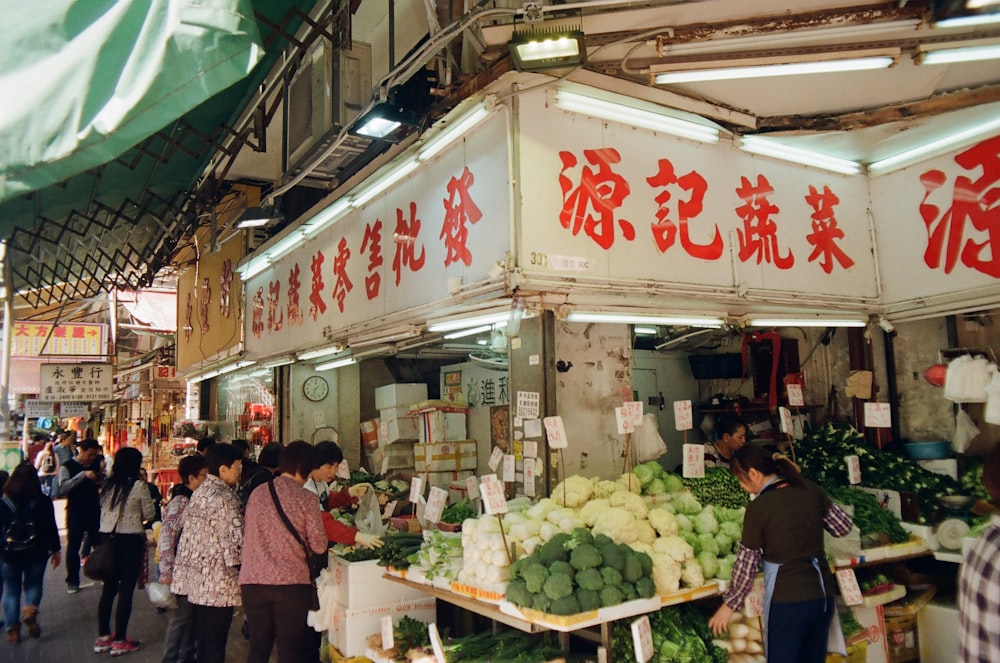 people at the vegetable station inside market