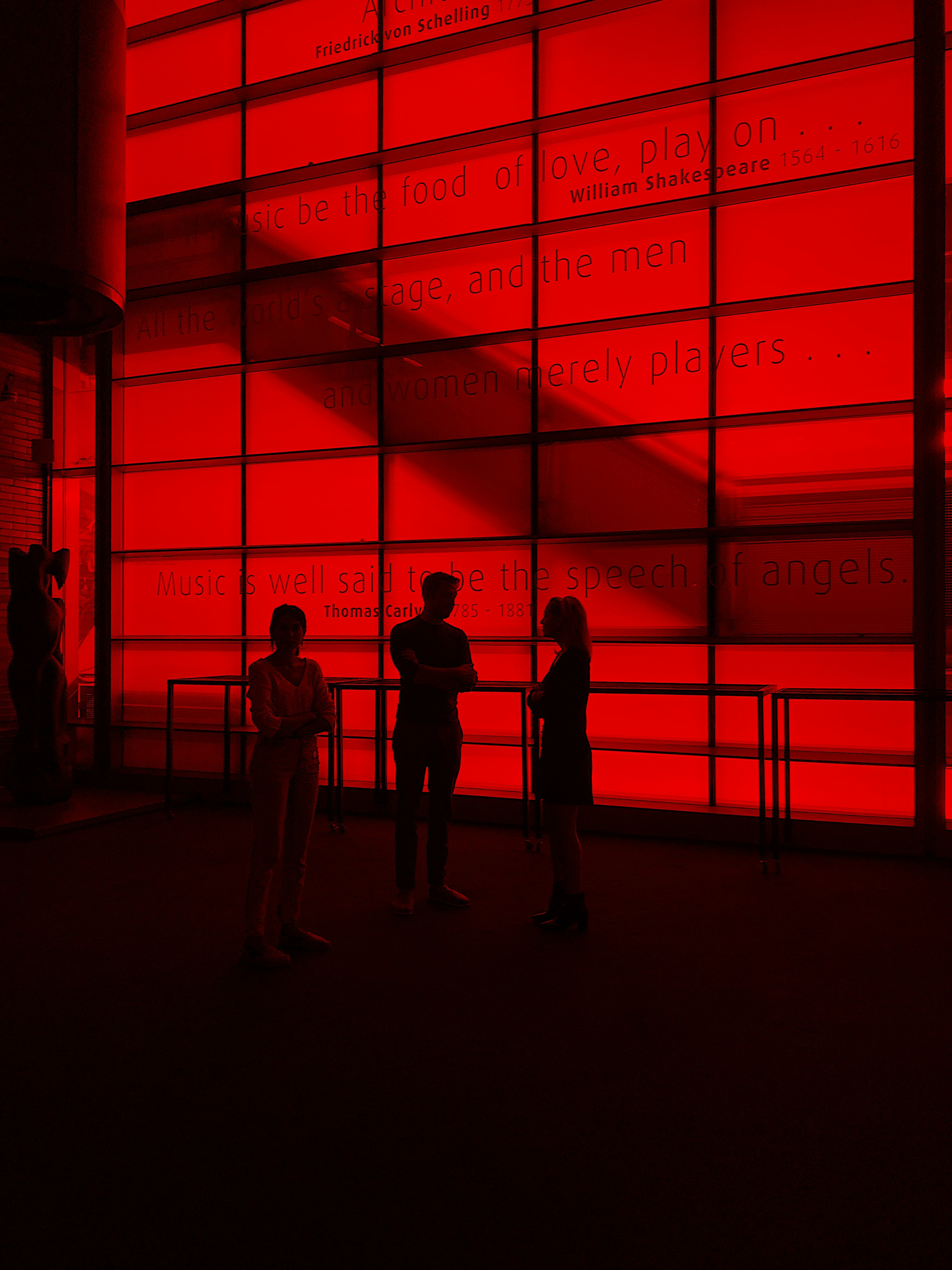 silhouette photography of three people inside a building