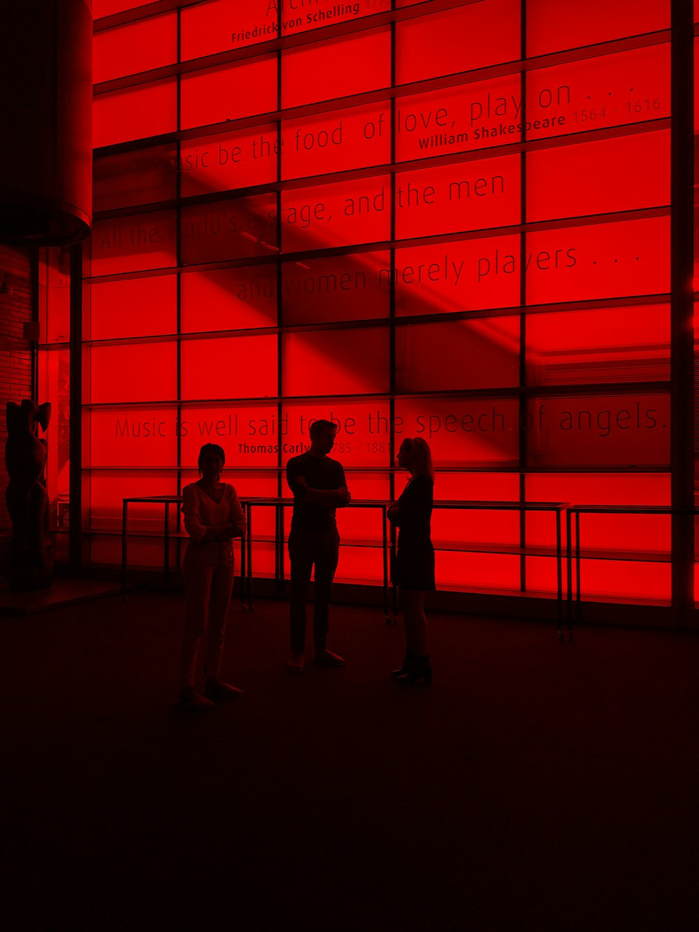 silhouette photography of three people inside a building