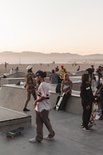 A group of diverse skaters smiling and skating together in a sunny park.
