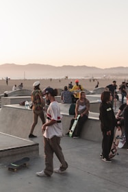 A group of skaters gathered at a local skate park enjoying a friendly competition.