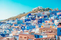 blue and white painted houses on the cliff