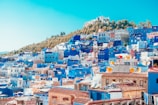 blue and white painted houses on the cliff