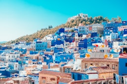 blue and white painted houses on the cliff