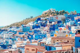 blue and white painted houses on the cliff