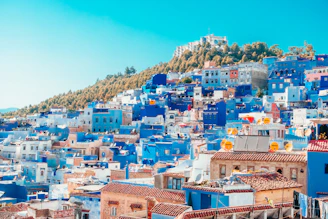 blue and white painted houses on the cliff
