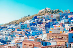 blue and white painted houses on the cliff