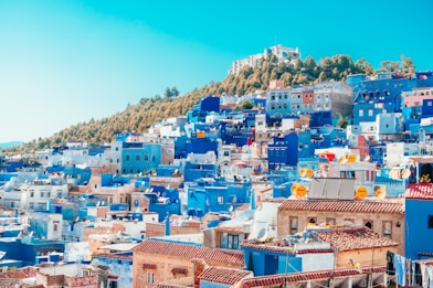 blue and white painted houses on the cliff
