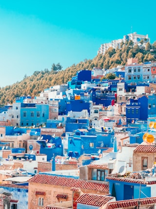 blue and white painted houses on the cliff